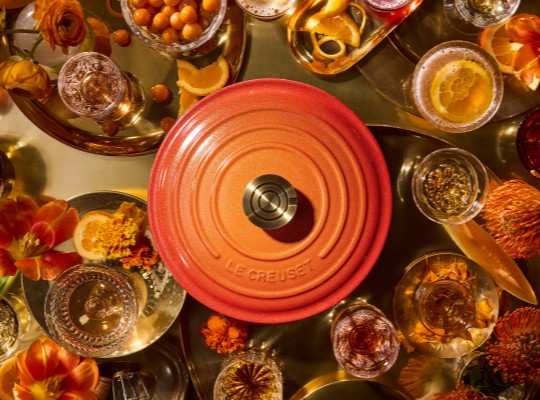detail of a cerise dutch oven in dramatic lighting